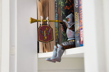 Bookshelf Guardian with Butt Trumpet Banner